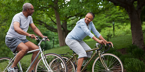 An older couple riding bicycles